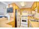 Kitchen showcasing wood cabinets, white appliances, and backsplash at 6001-Z16 S Kings Hwy., Myrtle Beach, SC 29575