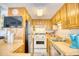 Cozy kitchen features wood cabinets, stainless refrigerator, and is equipped with dishwasher at 6001-Z16 S Kings Hwy., Myrtle Beach, SC 29575