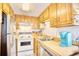 Bright kitchen features white tile backsplash, wood cabinets, and stainless steel refrigerator at 6001-Z16 S Kings Hwy., Myrtle Beach, SC 29575