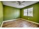 Bedroom with light green walls, hardwood floors and a window at 6633 W Sweetbriar Trail, Myrtle Beach, SC 29588