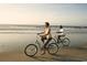 Couple enjoying a relaxing bike ride on the beach at 747 Isle Verde Dr, Myrtle Beach, SC 29579