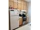 Kitchen with ample wood cabinets, stainless steel appliances, and refrigerator at 9502 Knights Ct., Myrtle Beach, SC 29572