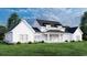 Back view of a white farmhouse with a large covered patio at 2172 Pettus Way, Surfside Beach, SC 29575