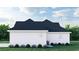 Side view of a white farmhouse with dark roof and landscaping at 2188 Pettus Way, Surfside Beach, SC 29575