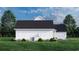 Rear view of a white farmhouse with AC unit and landscaping at 2172 Pettus Way, Surfside Beach, SC 29575