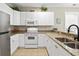 White cabinets, granite countertops, and stainless steel appliances in this kitchen at 1001 World Tour Blvd. # 101A, Myrtle Beach, SC 29579