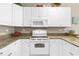 White kitchen with granite countertops and electric stove at 1001 World Tour Blvd. # 101A, Myrtle Beach, SC 29579