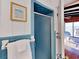 Small bathroom with shower and blue tile. Offers a view of ocean from the bedroom at 102 Seaview Loop, Pawleys Island, SC 29585