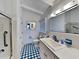 Clean bathroom with white vanity, blue patterned floor, and shower/tub combo at 102 Seaview Loop, Pawleys Island, SC 29585