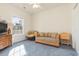 Small living room with wicker couch and round chair at 1058 Sea Mountain Hwy. # 1-303, North Myrtle Beach, SC 29582