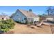 Landscaped backyard with stone patio, built-in firepit, green lawn and plantings providing privacy from neighboring homes at 1405 Osprey Pointe Ln., North Myrtle Beach, SC 29582