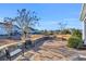 Backyard patio features a stone surface, outdoor furniture, and manicured landscaping with a view of neighboring homes at 1405 Osprey Pointe Ln., North Myrtle Beach, SC 29582