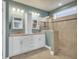 Bright bathroom featuring double sinks, granite countertops, white cabinets, and a glass shower at 1405 Osprey Pointe Ln., North Myrtle Beach, SC 29582