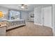 Bright bedroom featuring neutral carpet, ceiling fan, and a queen bed with blue and tan accents, dresser, and a bright window at 1405 Osprey Pointe Ln., North Myrtle Beach, SC 29582