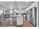 Modern kitchen features stainless appliances and island, blending seamlessly with the living area at 1405 Osprey Pointe Ln., North Myrtle Beach, SC 29582