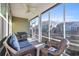 Relaxing screened porch with wicker seating, ceiling fan, and serene views of the backyard's patio and landscaping at 1405 Osprey Pointe Ln., North Myrtle Beach, SC 29582