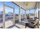 Inviting screened porch with comfortable wicker furniture overlooking a stone patio and landscaped backyard at 1405 Osprey Pointe Ln., North Myrtle Beach, SC 29582