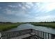 Serene dock with bench overlooking marsh and houses at 178 Salt Marsh Circle # 30-E, Pawleys Island, SC 29585