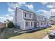 Gray multi-unit building with maroon window trim and a paved walkway at 1880 Colony Dr. # 12-H, Surfside Beach, SC 29575