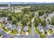 Aerial view showing the property's location in a neighborhood with trees and distant ocean views at 1900 Shell Ct., Surfside Beach, SC 29575