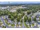 Aerial view showing the property's location in a neighborhood with trees and distant ocean views at 1900 Shell Ct., Surfside Beach, SC 29575