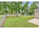 Backyard featuring mature trees, a well-kept lawn, and a chain-link fence at 1900 Shell Ct., Surfside Beach, SC 29575