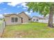 Exterior view of a backyard featuring a well-maintained lawn and partial fence at 1900 Shell Ct., Surfside Beach, SC 29575