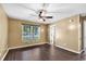 Bright bedroom featuring wood-look floors, neutral walls, and a large window at 1900 Shell Ct., Surfside Beach, SC 29575