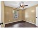 Bedroom featuring hardwood floors, a window, and a ceiling fan at 1900 Shell Ct., Surfside Beach, SC 29575