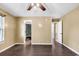 Bedroom featuring dark wood-look floors, ceiling fan, and access to the bathroom at 1900 Shell Ct., Surfside Beach, SC 29575