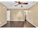 Bright bedroom featuring wood-look floors, ceiling fan, and closet access at 1900 Shell Ct., Surfside Beach, SC 29575
