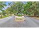 Picturesque entrance to Harbour Village featuring lush trees and manicured landscaping at 1900 Shell Ct., Surfside Beach, SC 29575