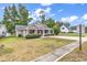 Charming single-story home featuring a cozy front porch, manicured lawn and mature landscaping at 1900 Shell Ct., Surfside Beach, SC 29575