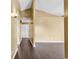 Hallway with warm tones, and dark hardwood floors leading to a white closet door at 1900 Shell Ct., Surfside Beach, SC 29575