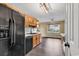Kitchen features wooden cabinets, black appliances and hardwood floors at 1900 Shell Ct., Surfside Beach, SC 29575