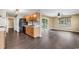 Spacious kitchen with wood cabinets and laminate flooring that opens to the living room at 1900 Shell Ct., Surfside Beach, SC 29575