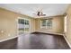 Bright living room with dark laminate flooring, large windows, and sliding glass doors at 1900 Shell Ct., Surfside Beach, SC 29575