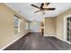 Open-concept living area with dark wood flooring, neutral walls, and plenty of natural light from the large windows at 1900 Shell Ct., Surfside Beach, SC 29575