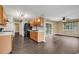 Open concept kitchen and living room with laminate floors and sliding glass doors to the backyard at 1900 Shell Ct., Surfside Beach, SC 29575