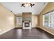 Spacious living room with a cozy fireplace, hardwood floors, and natural light at 1900 Shell Ct., Surfside Beach, SC 29575