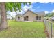 Expansive backyard showing a house with a sliding glass door, windows, and a well maintained lawn at 1900 Shell Ct., Surfside Beach, SC 29575