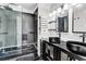 Modern bathroom features a stand-up shower, dark tile, and double sinks at 1900 Shell Ct., Surfside Beach, SC 29575