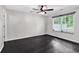 Bright bedroom with hardwood floors and a large window offering a pleasant outdoor view at 1900 Shell Ct., Surfside Beach, SC 29575
