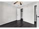 Bedroom with dark hardwood floors, overhead ceiling fan, neutral colored walls, and a closet at 1900 Shell Ct., Surfside Beach, SC 29575