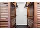 A walk-in closet that features wooden shelves and drawers at 1900 Shell Ct., Surfside Beach, SC 29575