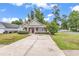 Charming single-story home featuring a well-manicured lawn and a concrete driveway leading to the entrance at 1900 Shell Ct., Surfside Beach, SC 29575