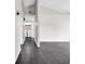 Bright hallway with sleek, dark hardwood floors, and a laundry area visible in the background at 1900 Shell Ct., Surfside Beach, SC 29575