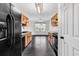 Long kitchen and dining area with wood cabinets and black appliances at 1900 Shell Ct., Surfside Beach, SC 29575