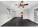 Bright living area features wood floors and a ceiling fan at 1900 Shell Ct., Surfside Beach, SC 29575