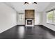 Bright living room boasts a modern fireplace feature wall and dark wood-look floors at 1900 Shell Ct., Surfside Beach, SC 29575
